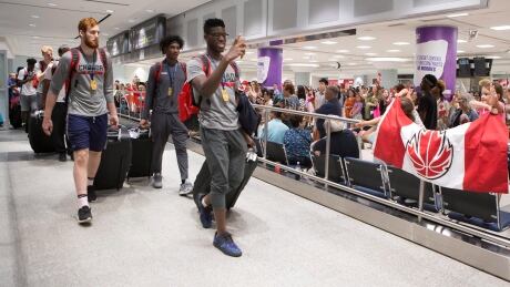 Amidou Bamba, front, arrives at Toronto's Pearson Airport Monday with other members of Canada's under-19 basketball team after winning gold at the U19 FIBA World Cup this past weekend. BKO U19 Italy Canada 20170710