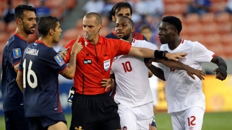 Canada's Alphonso Davies (12) and Costa Rica's Christian Gamboa (16) are separated by the referee during their Gold Cup match Tuesday in Houston. Gold Cup Costa Rica Canada Soccer