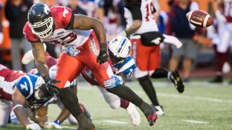 Calgary's Jerome Messam (33) loses the ball as he is tackled by the Montreal defence during the Alouettes's 30-23 win Friday night in Montreal. FBO CFL Stampeders Alouettes 20170714