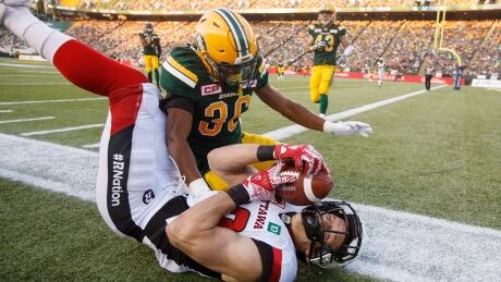 Greg Ellingson of the Redblacks reaches for a touchdown but falls short as Arjen Colquhoun of the Eskimos gives chase to help Edmonton defeat Ottawa 23-21 on Friday, in Edmonton, Alta. Redblacks-Eskimos-14072017