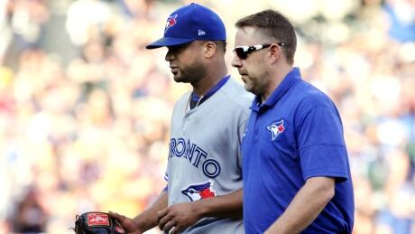 Francisco Liriano, centre, leaves the game against the Detroit Tigers with a trainer during the third inning. francisco-liriano