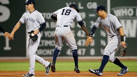 New York Yankees' Jacoby Ellsbury, Didi Gregoriusd and Aaron Judge, from left, celebrate after the Yankees defeated the Boston Red Sox 4-1 in 16 innings. yankees-red-sox