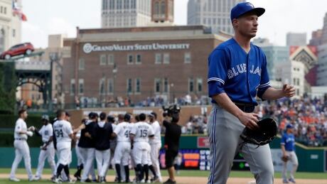 Blue Jays relief pitcher Lucas Harrell, foreground, walks off the field as the Detroit Tigers celebrate their 6-5 extra-innings win on Sunday, in Detroit. Jays-Tigers-16072017