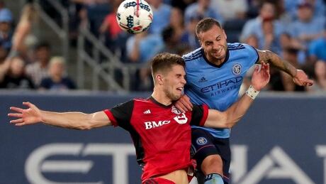 Toronto FC forward Ben Spencer, left, challenges New York City FC defender Maxime Chanot for control of the ball during their 2-2 tie on Wednesday in New York. MLS Toronto FC NYC FC Soccer