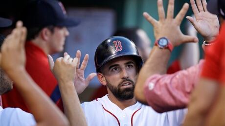 Boston Red Sox's Deven Marrero is congratulated after scoring on a two RBI single by Dustin Pedroia during the second inning against the Toronto Blue Jays Wednesday. jays-red-sox