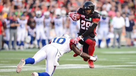 Ottawa Redblacks running back William Powell (29) is tackled by Montreal Alouettes linebacker Chris Ackie (10) during the first half of Ottawa's win Wednesday. alouettes-redblacks