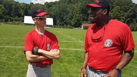 Former major leaguer Scott Bullett, right, lends his vast experience to one of his Ontario players. scott-bullet