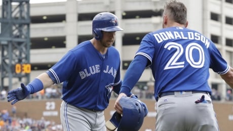 Toronto's Justin Smoak, left, is congratulated by Josh Donaldson after both scored on Smoak's two-run homer, one of two by the first baseman in the Jays' 8-6 win Thursday. Blue Jays Tigers Baseball
