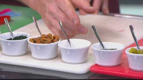James Coleridge shows what goes into Bella Gelateria's Coast to Coast gelato: (L to R) spirulina, pistachios, sea salt, candy sauce, lime zest, (not pictured) vanilla beans and kelp. What goes into Bella Gelateria's Coast to Coast