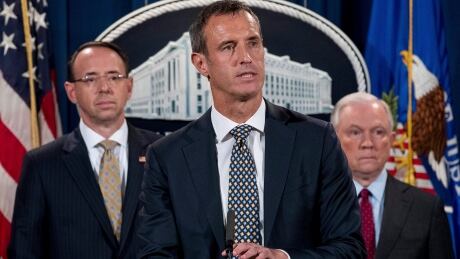 Europol Executive Director Robert Mark Wainwright, centre, accompanied by Attorney General Jeff Sessions, right, and by Deputy Attorney General Rod Rosenstein, left, speaks at a news conference to announce an international cybercrime enforcement action at the Department of Justice in Washington, D.C. on Thursday. Sessions Cybercrime