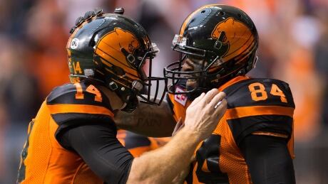 Emmanuel Arceneaux, right, celebrates a touchdown with teammate Travis Lulay during first half CFL action against the Winnipeg Blue Bombers on Friday, in Vancouver. Lions-bombers-21072017
