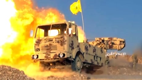 This frame grab from video released on Friday, July 21, 2017 and provided by the government-controlled Syrian Central Military Media, shows a Hezbollah cannon pounding militants' positions on the Lebanon-Syria border. Syria