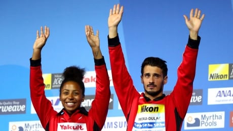 Jennifer Abel, left, celebrates her record-tying eighth world championship medal on Saturday, winning bronze with partner Francois Imbeau-Dulac. 700047474JD00165_Budapest_2