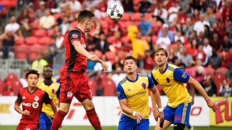 Toronto FC midfielder Jay Chapman (14) scores as Colorado Rapids defender Mike da Fonte (2) and Rapids defender Axel Sjoberg (44) look on during the first half. toronto-rapids