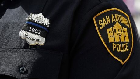A San Antonio police officer wears a black ribbon with the badge number of fellow officer officer Miguel Moreno during services, Friday, July 7, 2017, in San Antonio. Moreno died of wounds suffered when he and his partner were shot by a man they intended to question about a vehicle break-in last week. (AP Photo/Eric Gay) Police Shooting San Antonio