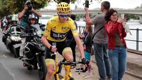 Britain's Chris Froome, wearing the overall leader's yellow jersey, holds a glass of champagne during the twenty-first and last stage of the Tour de France cycling race on Sunday. froome-chris-072317-620