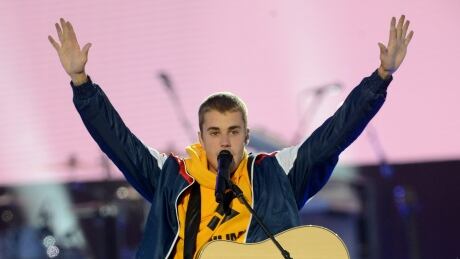Justin Bieber performs on stage at the One Love Manchester benefit concert in England in June. Bieber said he is fine after he cancelled the rest of his world tour Monday. 96111861