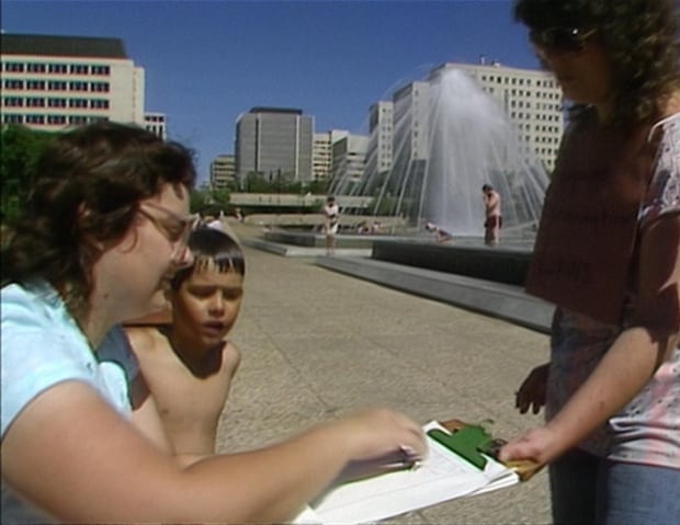 Woman signs petition