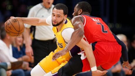 Tyler Ennis, left, appeared in 22 games for the Los Angeles Lakers, averaging 7.7 points and 2.4 assists. tyler-ennis