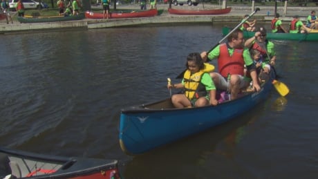 Sgt. Chris Hrnchiar, at the back of the canoe, paddles with Veldon Coburn during the 2017 Flotilla for Friendship in Ottawa. In between them is Napachie Pootoogook, the daughter of Inuk artist Annie Pootogook whom Coburn adopted in 2014. flotilla friendship chris hrnchiar veldon coburn canoe