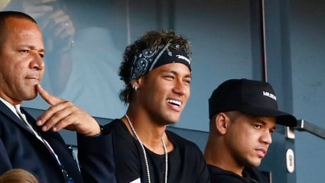 Brazilian soccer star Neymar, seen watching his new Paris Saint-Germain teammates last weekend, has still not received clearance to suit up for his new club after being transferred from Barcelona for a record $262 million US. neymar-080517-620