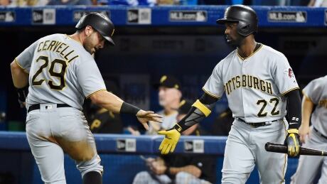 Francisco Cervelli, left, scores one of four unearned run for the Pirates in the fourth inning as Pittsburgh defeated Toronto 4-2 on Friday. pittsburgh-pirates