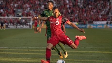 Toronto FC's Justin Morrow scores his team's first goal as Portland Timbers' Alvas Powell trails during second half. morrow-justin