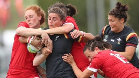 Wales' Jess Kavanagh-Williams, centre, is tackled by Canada's Alex Tessier during the 2017 Women's Rugby World Cup, Pool A match in Dublin, Ireland, on Sunday. canada-womens-rugby-world-cup-081317-620