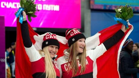 Canada's Kaillie Humphries (left) and Heather Moyse celebrate their gold medal win in women's bobsled at the Sochi Olympics on Feb. 19, 2014. Humphries says she has never tried weed but knows of athletes who use it for recovery. humphries-moyse-021914-620