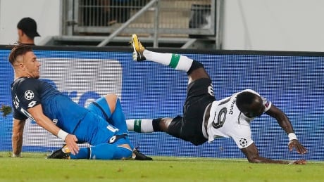 Liverpool's Said Mane is taken down by Hoffenheim's Ermin Bicakcic during their Champions League qualifier Tuesday in Sinsheim, Germany. Germany Soccer Champions League