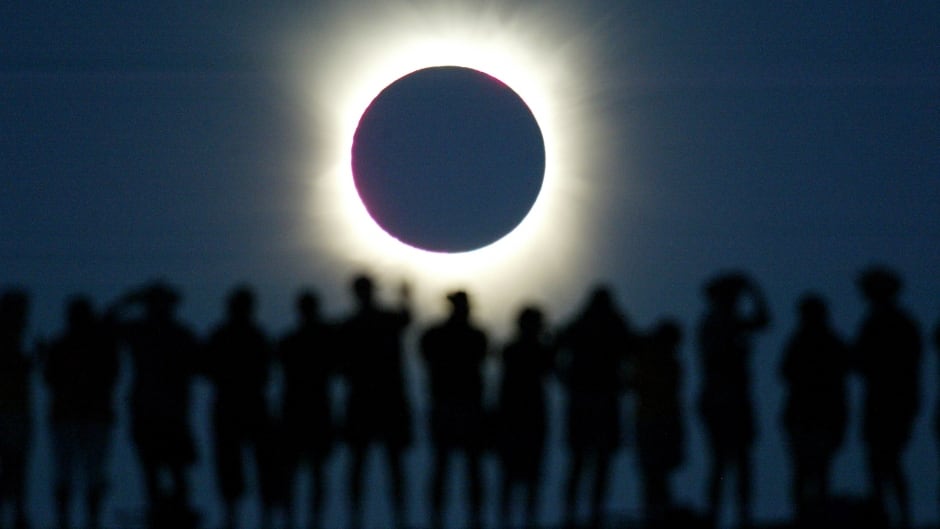 Tourists watch the sun being blocked by the moon during a solar eclipse
in the Australian outback town of Lyndhurst, located around 700
kilometres (437 miles) north of Adelaide December 4, 2002. The town is
one of only four in Australia where the 26 second-long full eclipse of
the sun could be seen and occurred during celebrations for the Year of
the Outback. The shadow path of whats called totality, where the
'diamond ring' effect becomes visible, can be seen on a path that is
just 36 kilometres wide. REUTERS/David Gray
DG/CP - RTREU1E