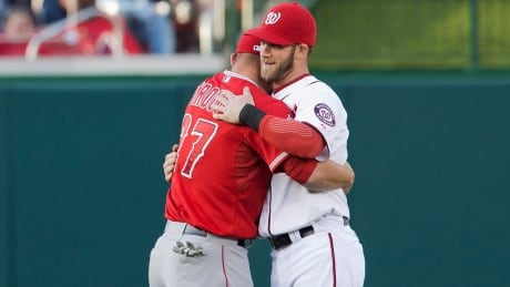 Los Angeles Angels' Mike Trout, left, and Washington Nationals' Bryce Harper, right, hug before a game during the 2014 season. mike-trout-bryce-harper