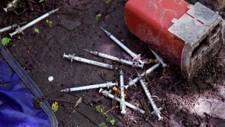 This Wednesday, June 7, 2017 photo shows discarded used hypodermic needles without protective sheaths at an encampment where opioid addicts shoot up along the Merrimack River in Lowell, Mass. Syringes left by drug users amid the heroin crisis are turning up everywhere. They hide in weeds along hiking trails and in playground grass, get washed into rivers and onto beaches, and lie scattered about in baseball dugouts and on sidewalks and streets. There are reports of children finding them and getting poked. APTOPIX Needles Everywhere