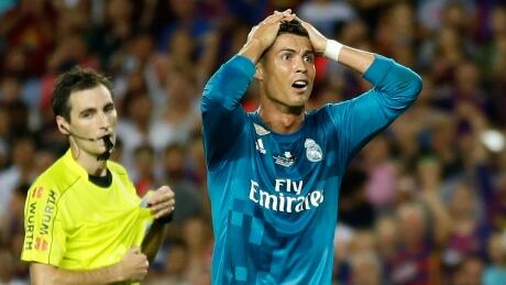 Real Madrid's Cristiano Ronaldo, right, reacts after referee Ricardo de Burgos shows a second yellow card during the Spanish Super Cup. ronaldo-cristiano