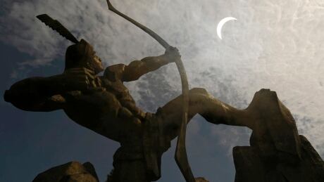 A statue of Houyi, a Chinese legendary hero who shot down nine suns with his bow and arrow, is silhouetted against a partial solar eclipse in Changzhi, Shanxi province July 22, 2009. The longest total solar eclipse of the 21st century began its flight on Wednesday across a narrow path of Asia, where it was expected to darken the skies for millions of people for more than six minutes in some places. Picture taken with double exposure. REUTERS/Stringer (CHINA SOCIETY) CHINA OUT. NO COMMERCIAL OR EDITORIAL SALES IN CHINA - RTR25WUJ CHINA/