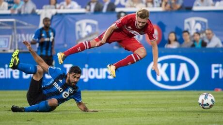 Chicago Fire midfielder Djordje Mihailovic trips over Montreal Impact defender Victor Cabrera during the Impact's win in Montreal on Wednesday. SOC MLS Fire Impact 20170816
