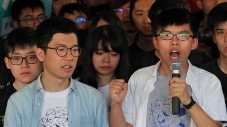 Hong Kong activist Joshua Wong, right, and Nathan Law, left, speak outside the high court before a ruling on a prosecution request for stiffer sentences following a lower court decision that let them avoid prison in Hong Kong, Thursday, Aug. 17, 2017. Young Hong Kong activist Wong and two other student leaders of huge pro-democracy protests in 2014 braced for a court decision Thursday that could send them to prison. The three were found guilty of leading or encouraging an illegal rally in September 2014 that kicked off the demonstrations known as the "Umbrella Movement." (AP Photo/Vincent Yu) APTOPIX Hong Kong Protest Leaders