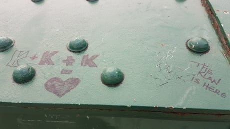 The messages 'The Klan is here' and other references to white supremacist group, the Ku Klux Klan, were found on this bridge railing at The Forks Thursday. Racist graffiti at The Forks