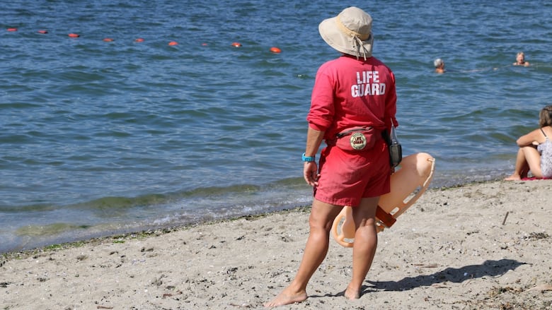 A lifeguard scans the water at Vancouver's Kitsilano Beach.