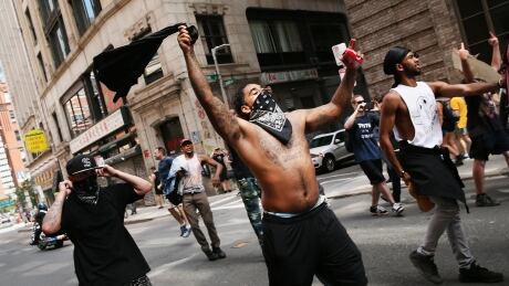 Protesters face off with riot police escorting conservative activists following a march in Boston against a planned 'Free Speech Rally.' It comes just one week after the violent 'Unite the Right' rally in Virginia left one woman dead and dozens more injured. 97102165
