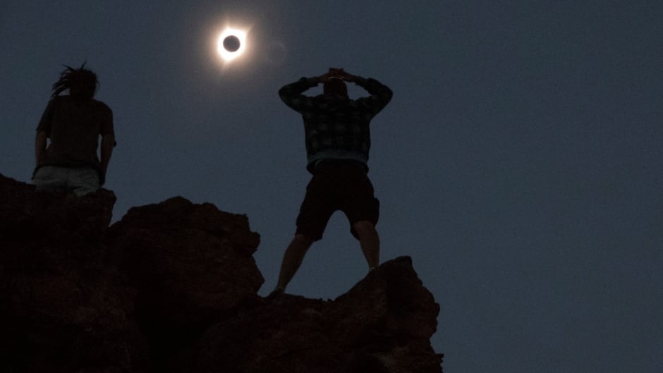 Enthusiasts watch a total solar eclipse while standing atop Carroll Rim Trail near Mitchell, Oregon, U.S. August 21, 2017.