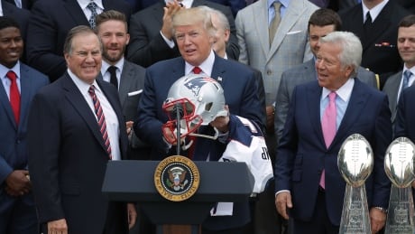 New England Patriots Head Coach Bill Belichick, left, and team owner Robert Kraft, right, present a football helmet to U.S. President Donald Trump during a celebration of the team's Super Bowl in April. trump-donald-kraft-patriots