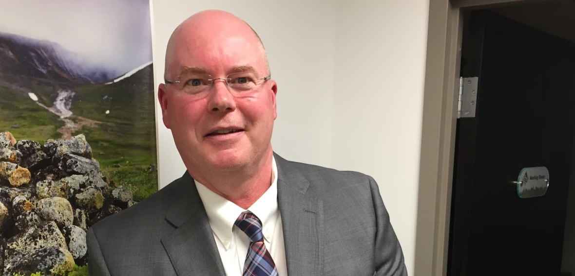 Bald man in suit.