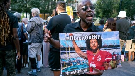 Eric Hamilton of New York joins others gathered in support of unsigned NFL quarterback Colin Kaepernick on Wednesday in front of NFL headquarters in New York. colin-kaepernick-rally