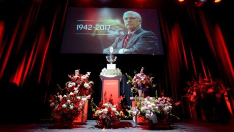 The Jack Adams Award, won by Bryan Murray in 1984 as coach of the Washington Capitals, is seen among flowers at a memorial for Murray, former coach and general manager of the Ottawa Senators, who died of colon cancer on Aug. 12. bryan-murray