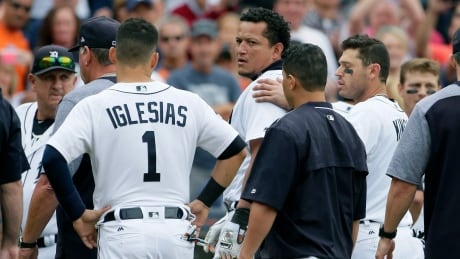 Detroit Tigers' Miguel Cabrera looks back at the New York Yankees as he is guided off the field by teammate Ian Kinsler, right, and Jose Iglesias (1) following a bench-clearing fight during the sixth inning of a game on Thursday afternoon. carbrera-tigers