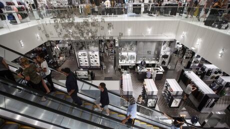Shoppers ride an escalator in the Simons store at Londonderry Mall in Edmonton on Saturday, Aug.26, 2017. Simons Retail Expansion 20170827