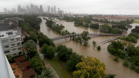 Downtown Houston is seen in the background on Monday past flooding caused by heavy rains from Tropical Storm Harvey. Harvey