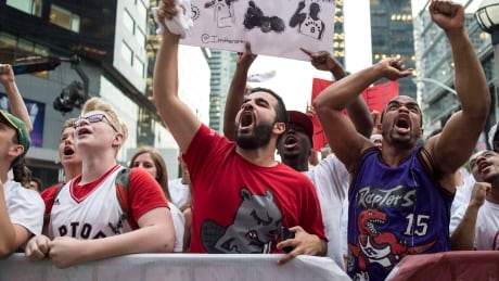 Toronto Raptors' fans watch the action on the big screen outside the Air Canada Centre during game six of the Eastern Conference final NBA playoff basketball action against the Cleveland Cavaliers in Toronto on Friday, May 27, 2016. THE CANADIAN PRESS/Eduardo Lima BKN Cavaliers Raptors 20160527