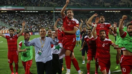 Syria's national soccer team celebrates after earning a spot in the playoffs and keeping their World Cup hopes alive. Iran Syria World Cup Soccer
